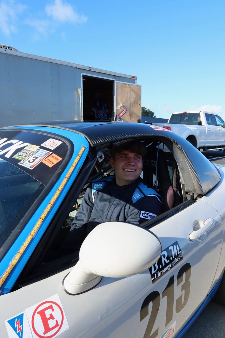 Carsten smiling from the cockpit of a race car